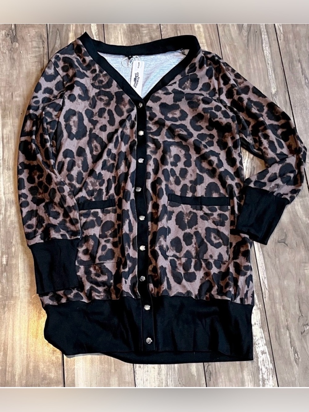 Styleworld leopard print cardigan sweater with black trim and pockets.